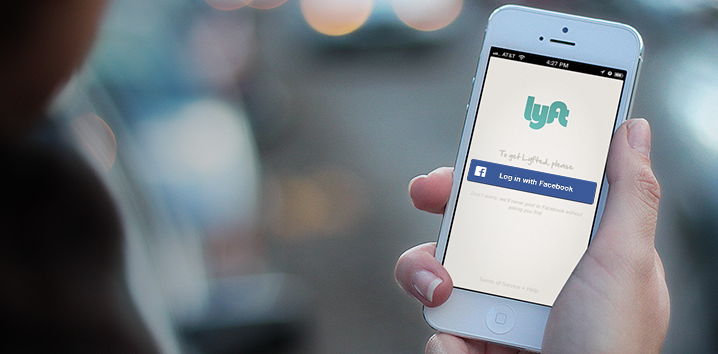Image showing a person holding an iPhone running the Lyft mobile app, with a “Login with Facebook” button prominently featured.
