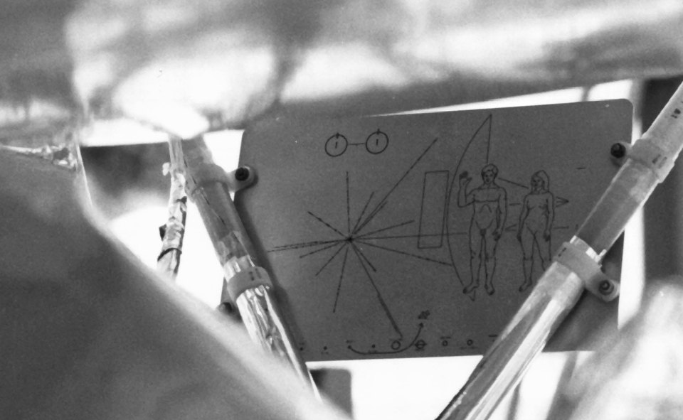 A black-and-white photograph of the Pioneer plaque affixed to the underside of the space probe.